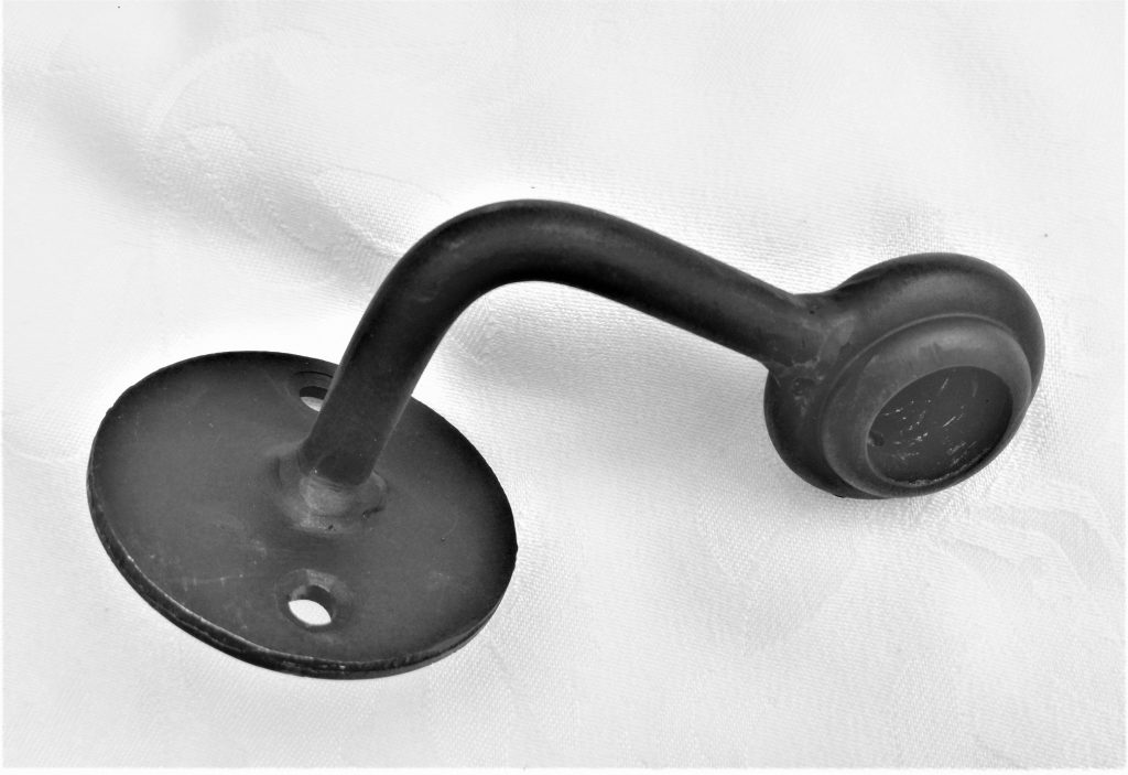 a black metal hook on a white surface