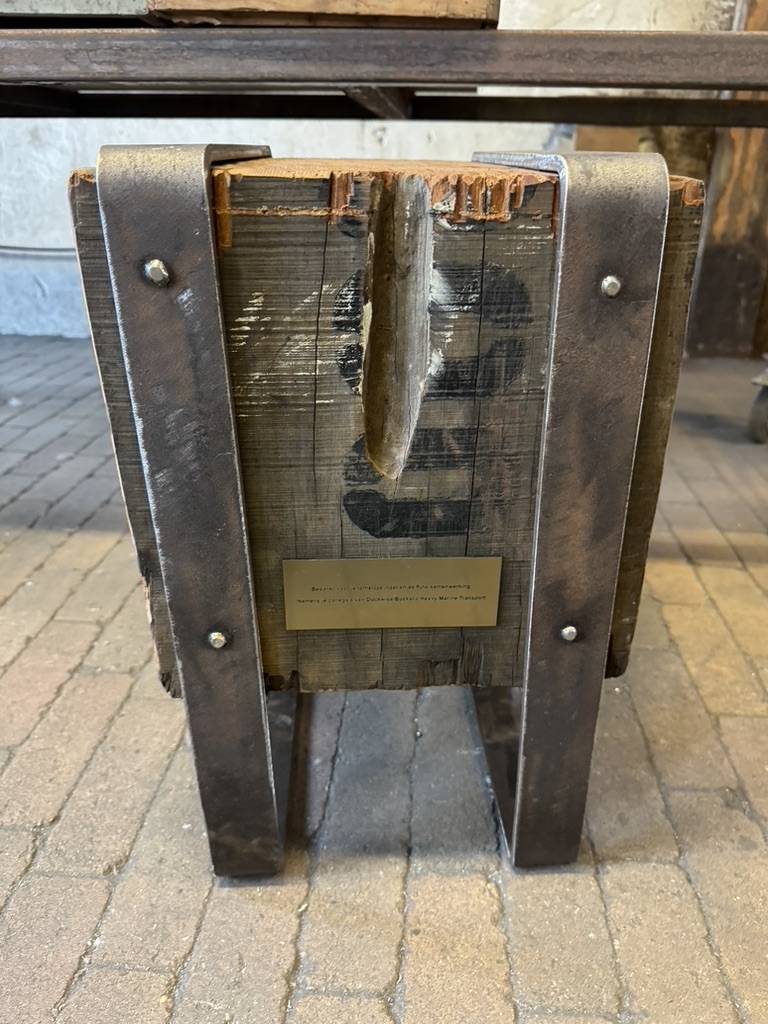 a wooden box with metal legs